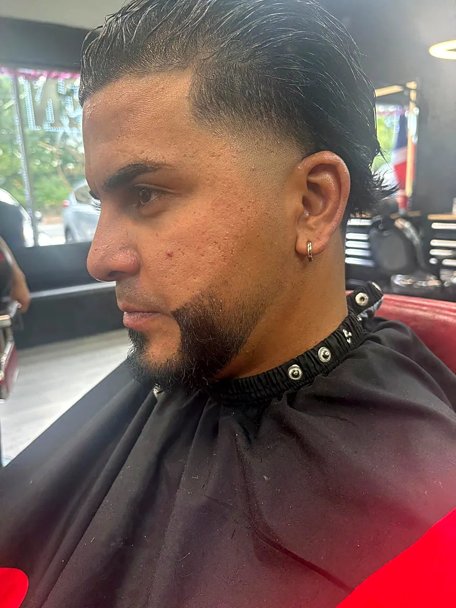 Taper fade with slick back and beard line-up